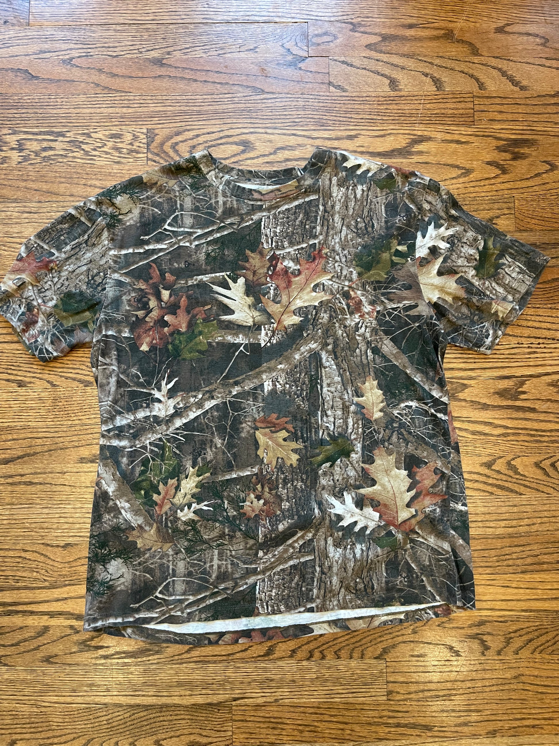 Camouflage-patterned shirt on a wooden floor