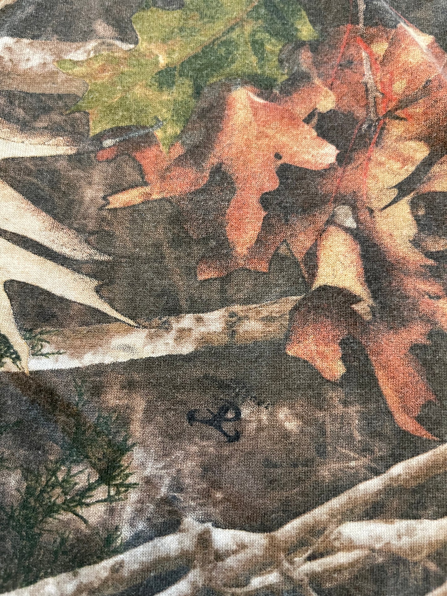 Close-up of a camouflage pattern with leaves and branches
