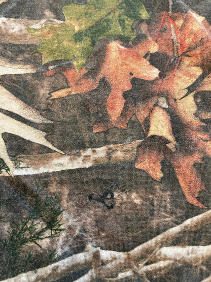 Close-up of a camouflage pattern with leaves and branches