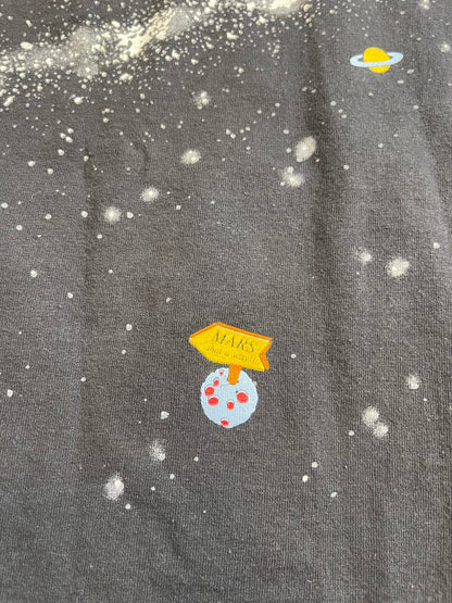 Textured fabric with cartoonish space-themed decorations including planets and stars.